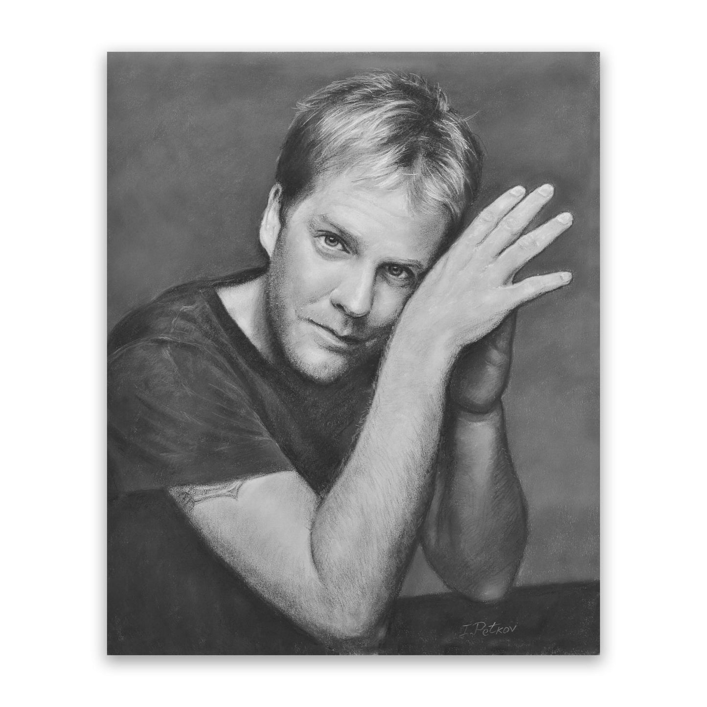 Black and white pastel and charcoal portrait of a Caucasian man with nice hair, dark eyes, and a five o’clock shadow. He is wearing a dark shirt, and has his arms and elbows on the table. He has turned his head slightly and is looking straight at the camera.