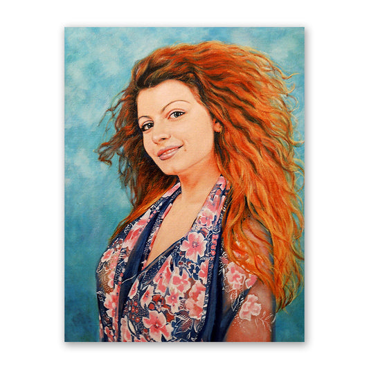 Oil portrait of a beautiful woman with curly, fiery-red hair, against a blue background. Ginger woman with fair skin and blue eyes, wearing a dark blue top with a pink floral pattern.